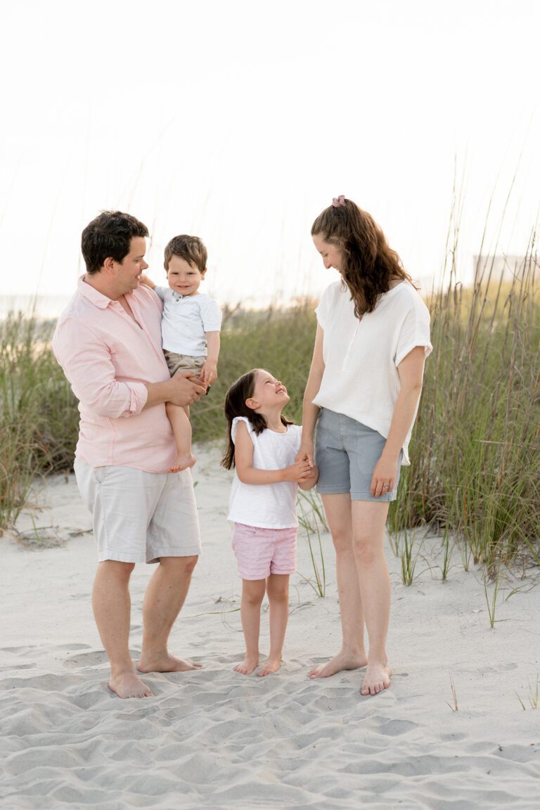 a family standing on a beach. Portrait - Photography, Portrait - Photographers